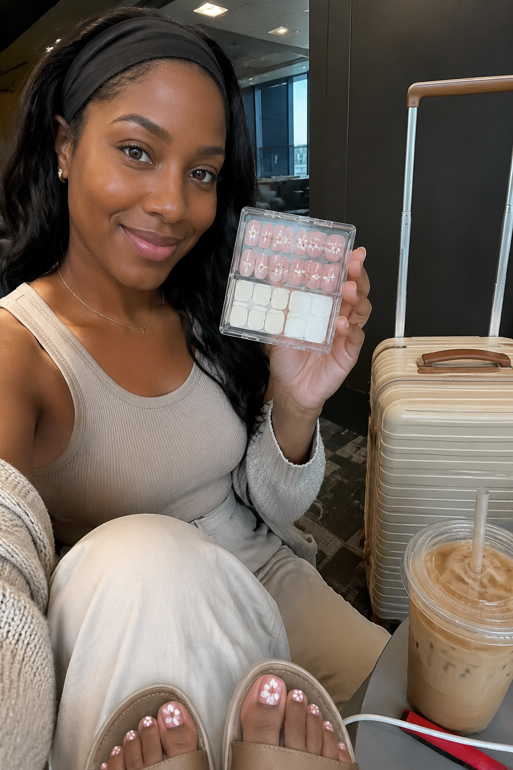 Travel creator airport selfie holding floral press-on nail tray
